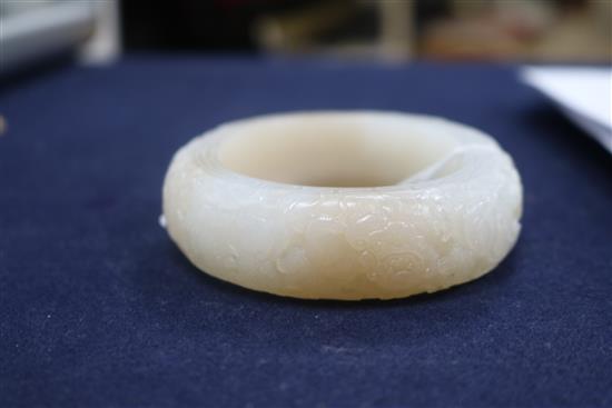 A Chinese white and russet jade bangle